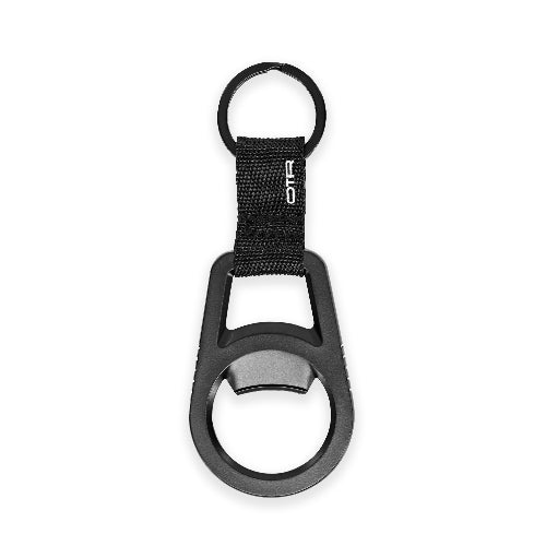 A black bottle opener keychain with a textured metal ring, a black webbed strap featuring the white 'OTR' logo, and a key ring